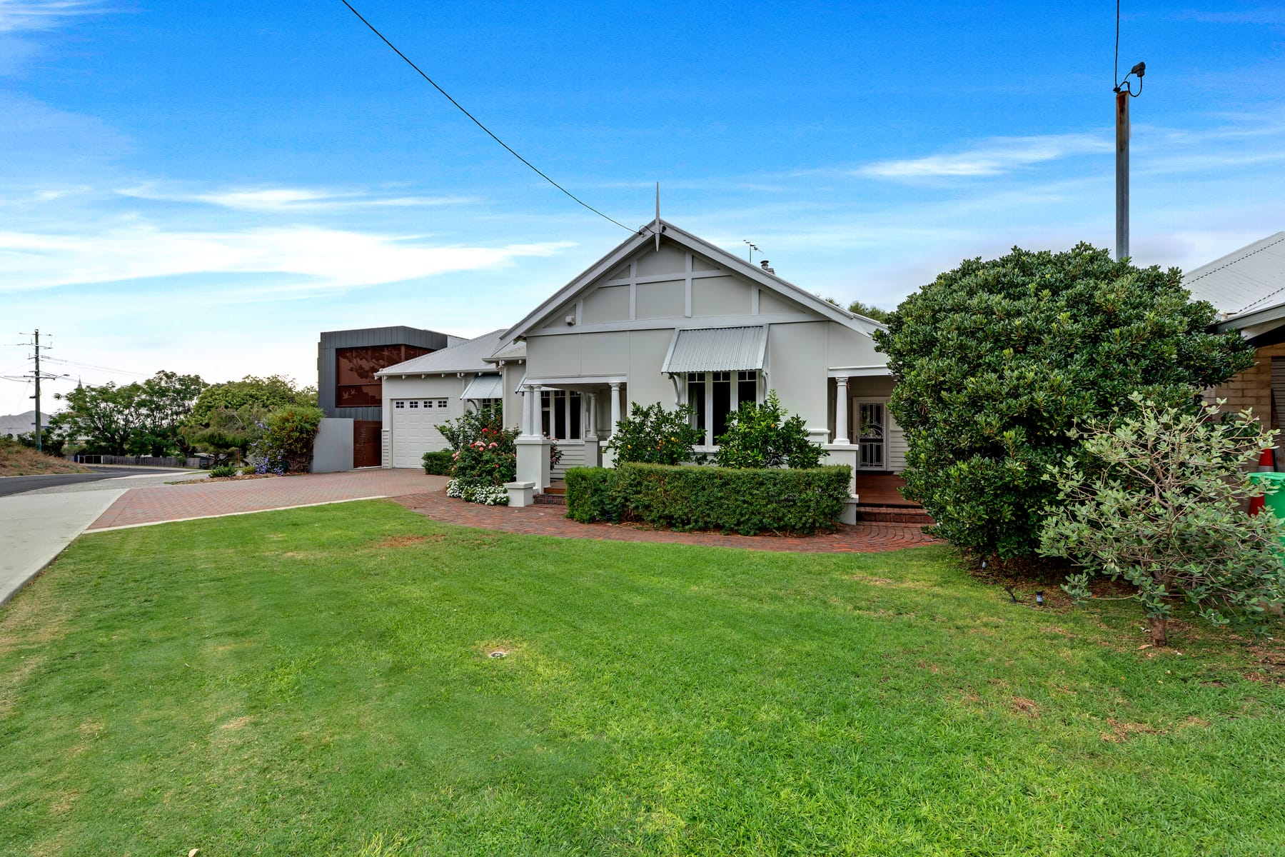 Character home with a broad front lawn and established garden