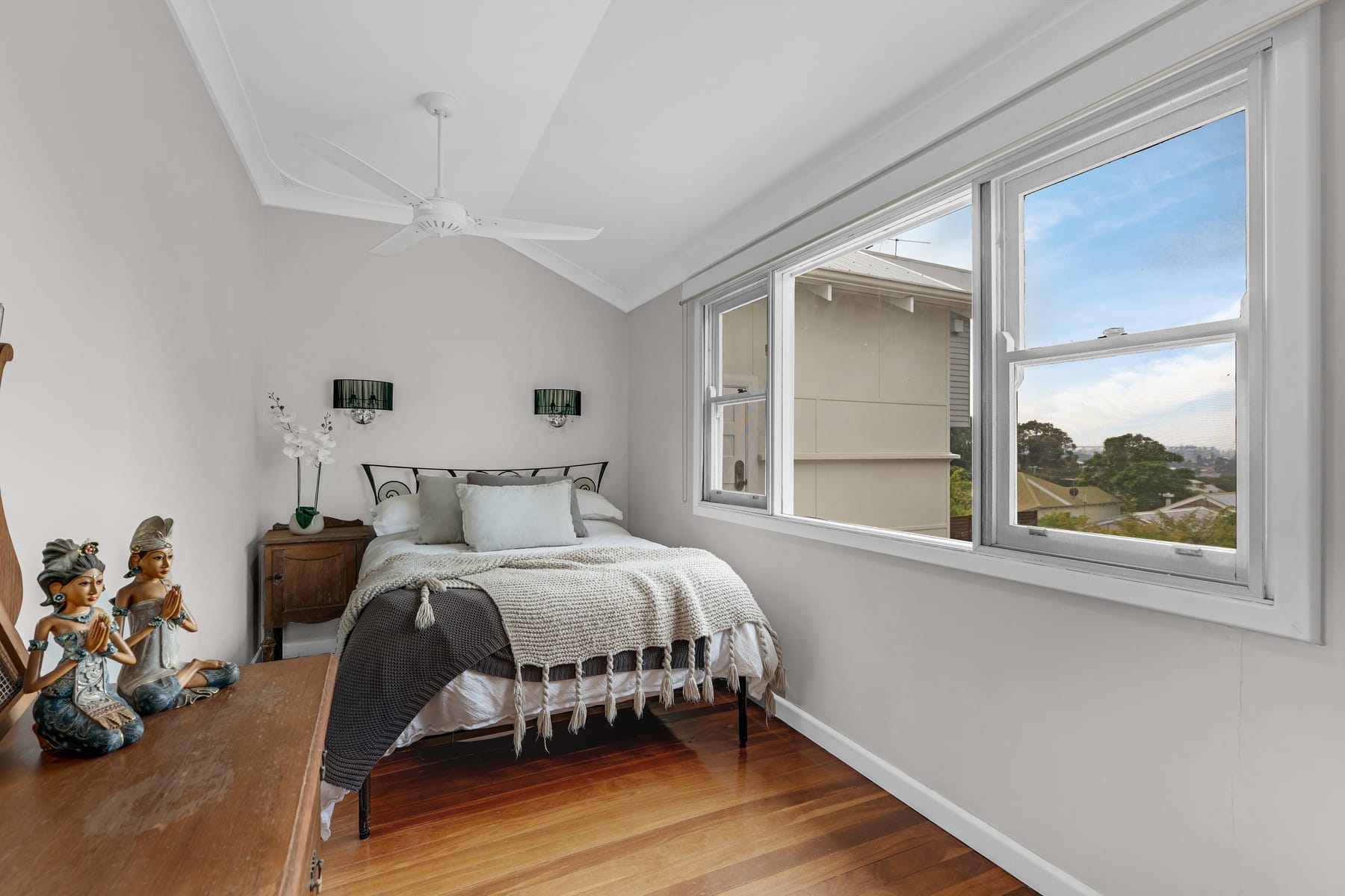 Bright bedroom with timber floors and wide windows