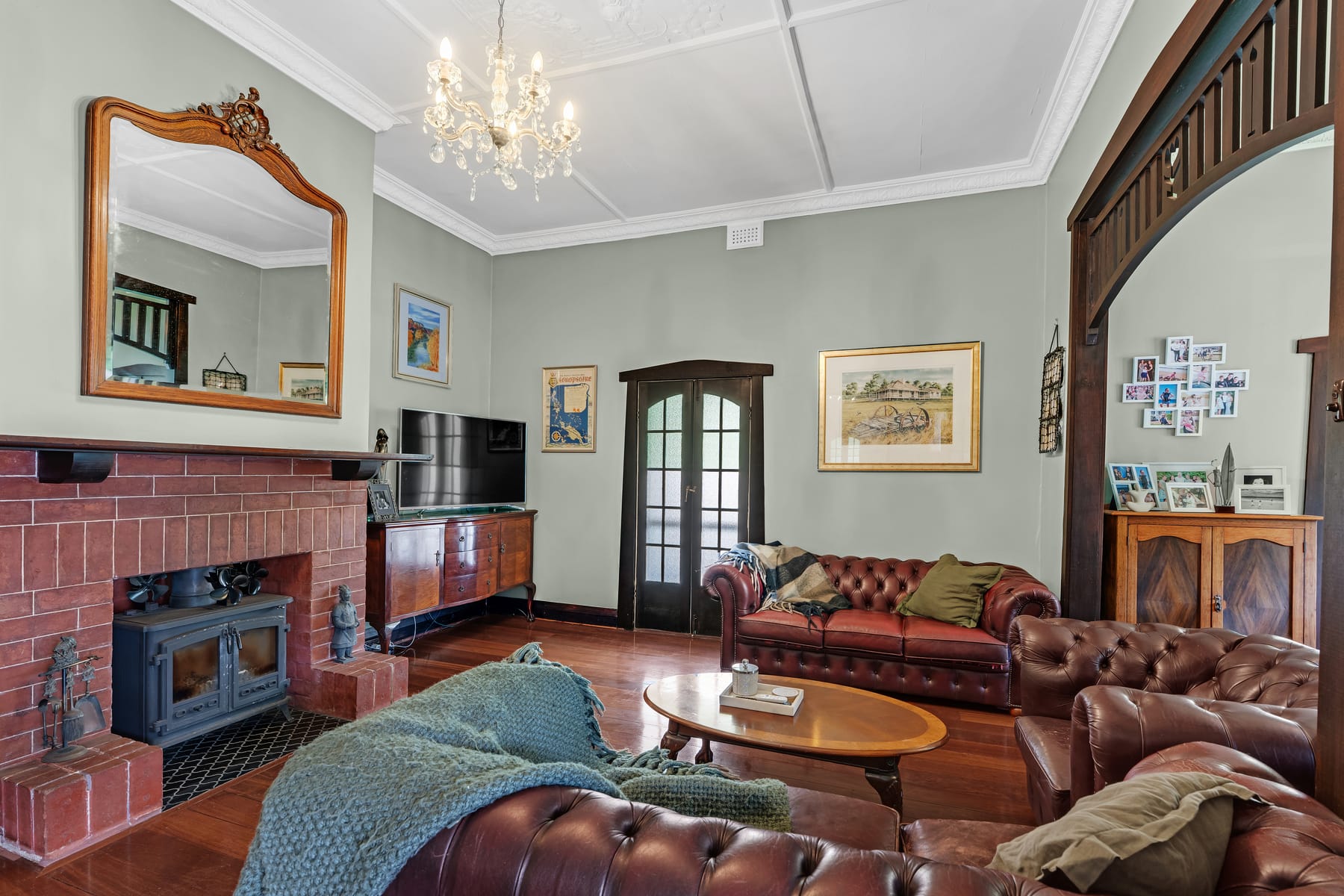 Character living room with timber floors and brick fireplace