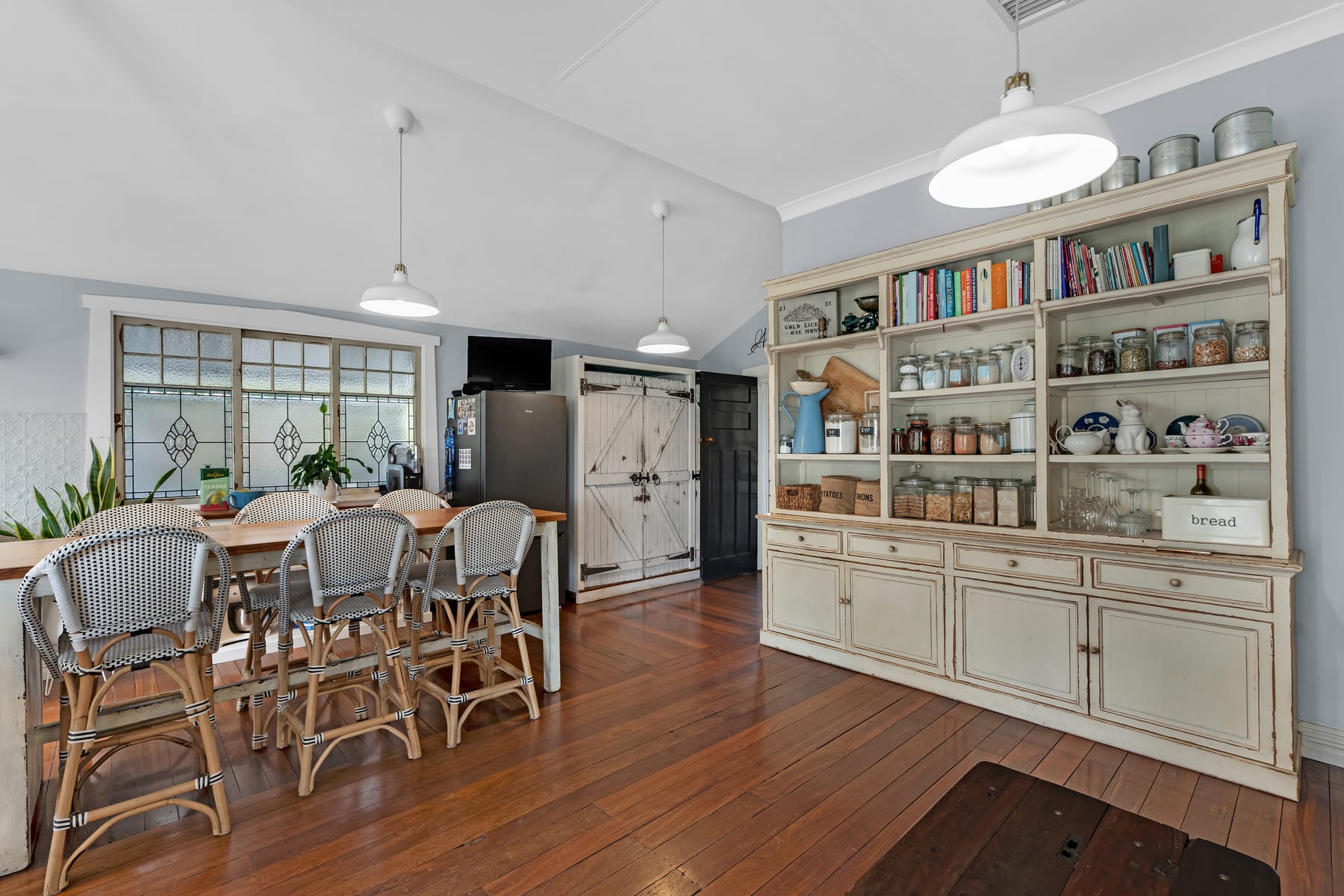 Country-style kitchen with timber floors and open shelving