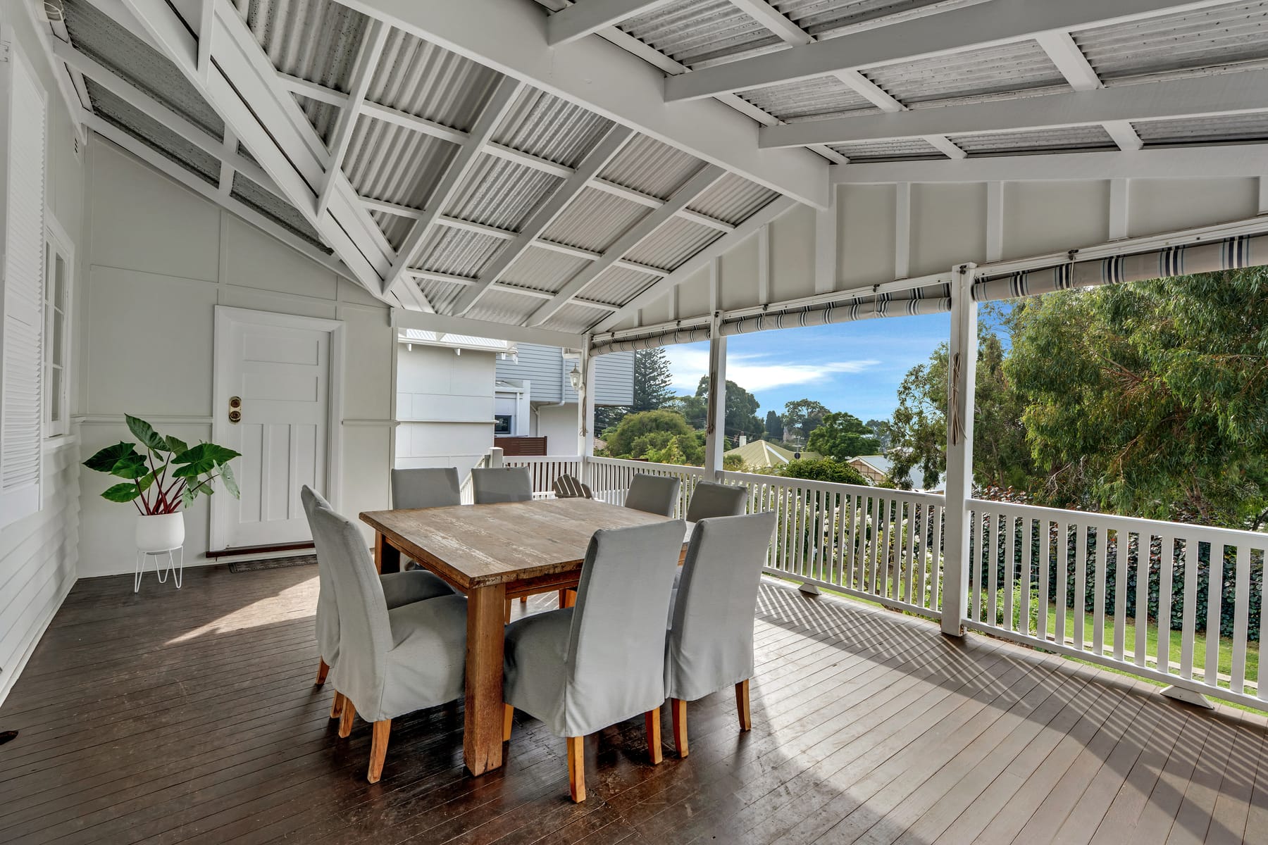 Covered veranda with outdoor dining and garden views